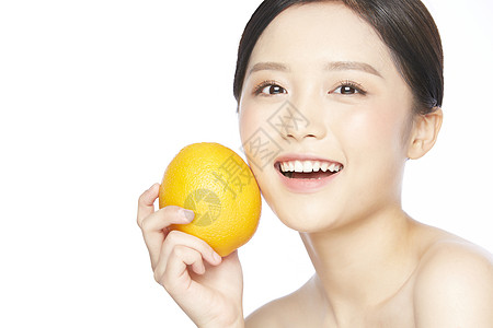 美女拿桔子护肤女性拿着橙子背景
