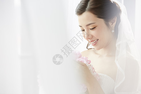 披着婚纱的新娘抱着手捧花图片