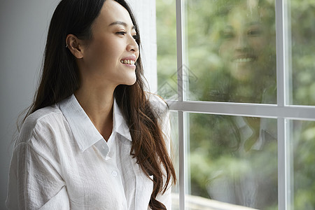 居家看向窗外的年轻女子高清图片