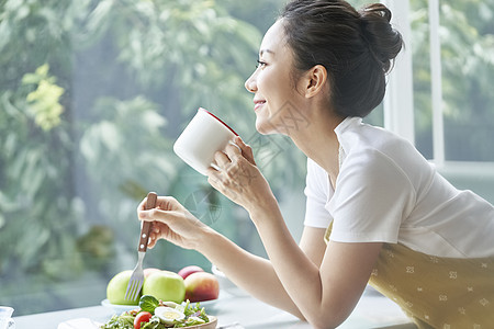 独自用餐喝咖啡的年轻女子图片