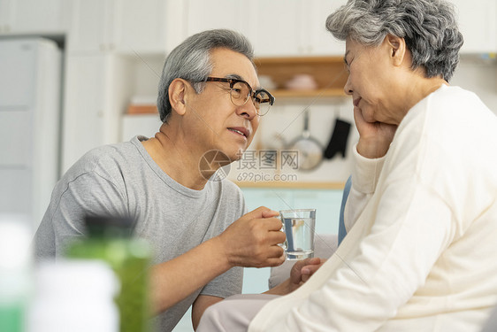 老年人担心的看着头疼不适的老伴图片