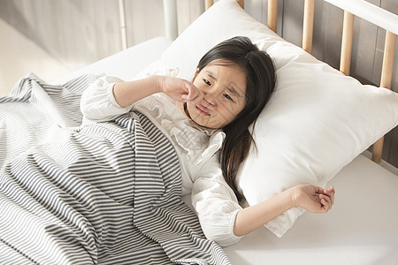 生病的小女孩躺在床上图片
