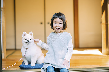 院子里的小女孩和博美犬图片