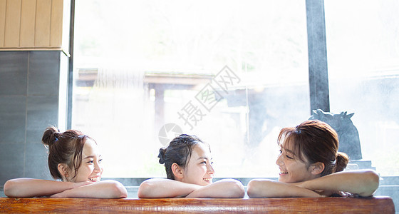 长假愉快复制空间妇女和朋友享受露天浴池图片
