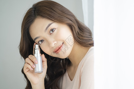 面部表情女美妝女人手里拿着化妆品的肖像图片素材