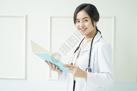 拿着文件夹微笑的女性医生图片