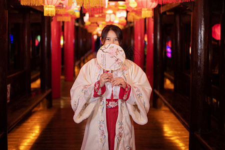 花灯灯会少女用扇子挡住下巴背景图片