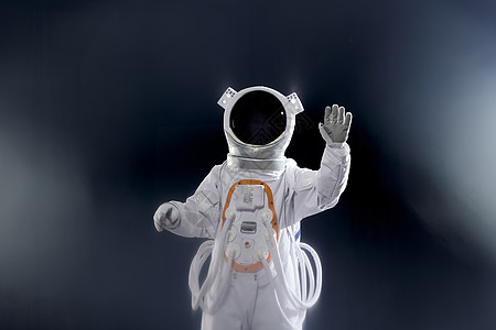 Vr宇宙创意宇航员空中触碰虚拟屏幕背景