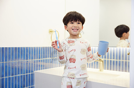 穿着睡衣在洗漱台刷牙的小男孩图片