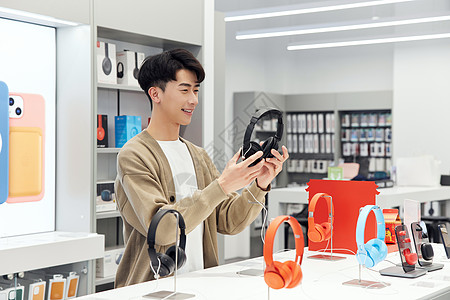 数码产品店挑选耳机的帅哥图片