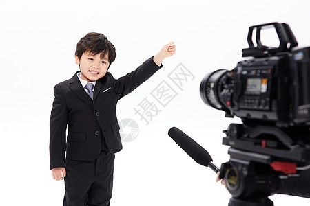 镜头前接受采访的可爱小男孩图片