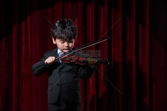 舞台上演奏小提琴的小男孩图片