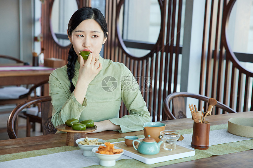在茶馆吃青团品茶的气质女性图片