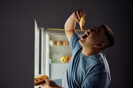 半夜肥胖男青年冰箱吃夜宵图片