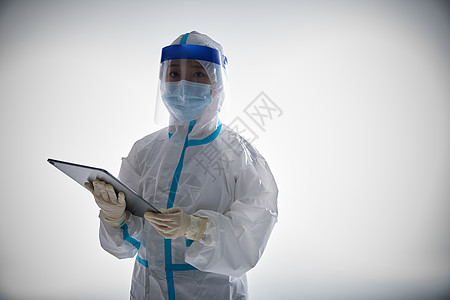 穿防护服的医护人员手拿平板电脑图片