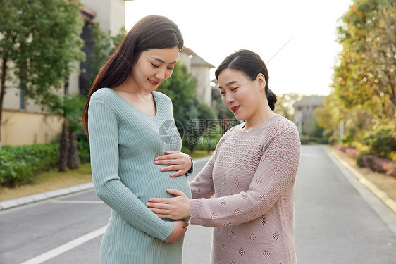 妈妈陪怀孕的女儿外出散步图片