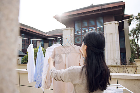 收拾衣服晾晒衣服的女性形象背景