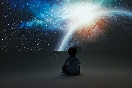 坐在地上探索宇宙奥秘的小男孩图片