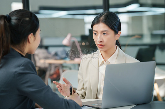 青年女设计师和顾客交谈图片