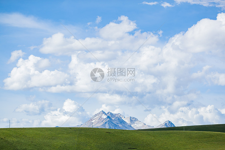 蓝天白云草原深处的雪山图片