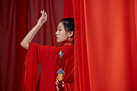 古代女子古风汉服女子手拿剑柄背景