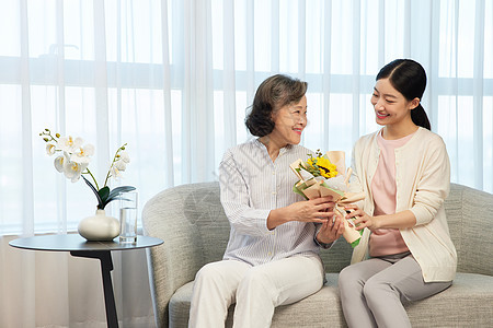 女儿手拿花束探望独居老人图片