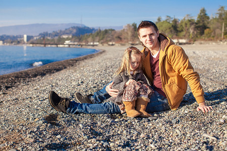 年幼的父亲和女儿在阳光明媚的冬图片