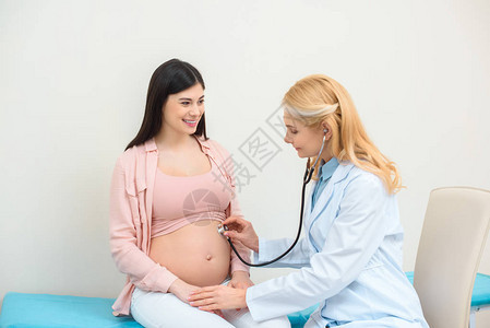 妇产科医生用听诊器听孕妇胎儿的心跳图片