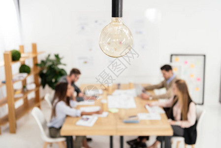 在办公室工作的销售经理有选择地强调灯泡和多文化的营销经理图片