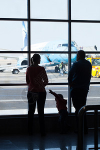 年轻的家庭在机场观看飞机图片