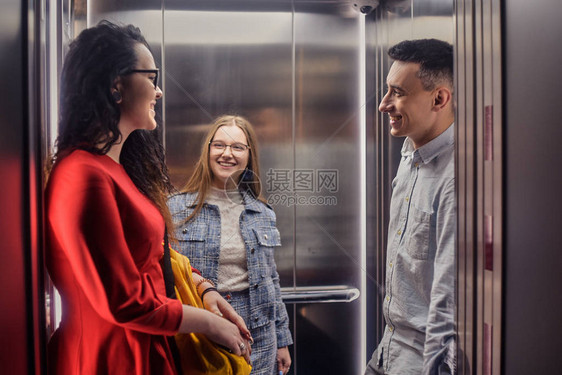 女孩和男孩乘坐电梯电梯里的学生去学习电梯里的人电梯与人图片