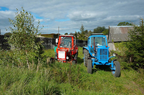 院子里有红蓝拖拉机木屋附近的村子里图片