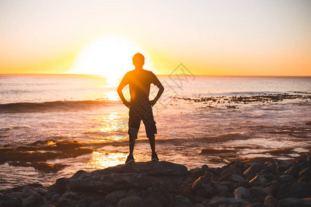 海滩地平线的年轻人剪影图片