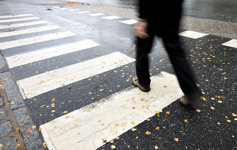 潮湿的秋日黑色过马路的男人图片
