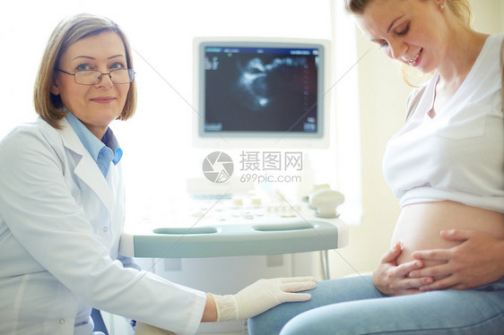 孕妇和医生在医院定期检查期间快乐的怀孕妇图片