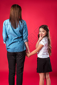 女儿握着母亲的手在红色上隔图片