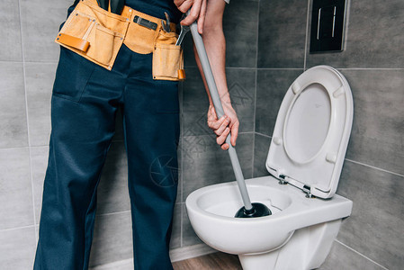 男水管工在浴室内使用灌木机和清洁厕所部分观图片