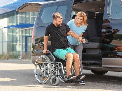 帮助残疾男子坐车的妇女帮助残图片