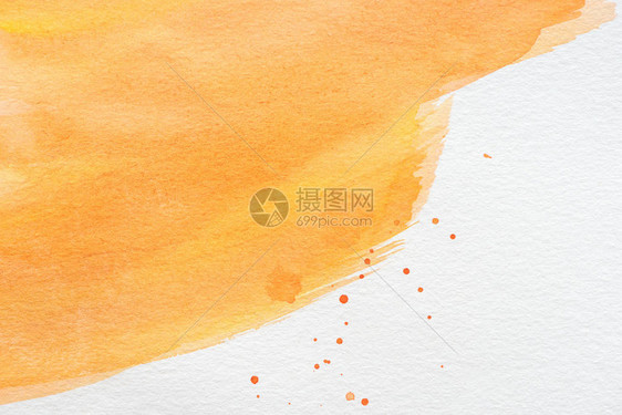 抽象的橙色水彩画与白纸上的油漆污点图片
