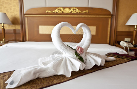 用鲜花和毛巾装饰的蜜月床套房图片