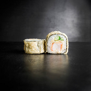 深灰色背景中的美味寿司卷图片