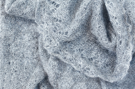 编织的羊毛织物灰披肩带皱纹和折叠的服装背景图片