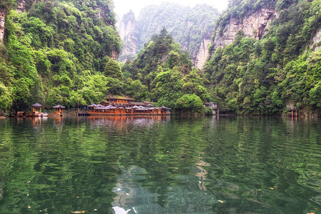 宝峰湖风景与茂密的森林环绕着高大的石峰森林中的小码头张家界背景图片
