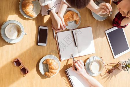 坐在咖啡休息时间的女青年与数字设备商业午餐一起图片