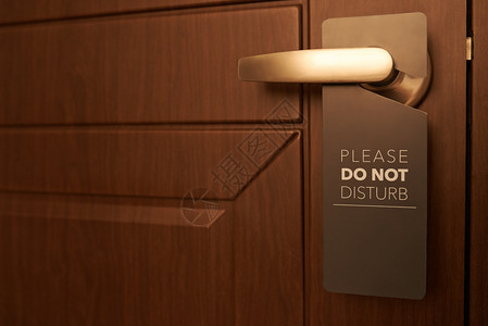 带有请勿打扰标志的酒店房间的紧闭门图片