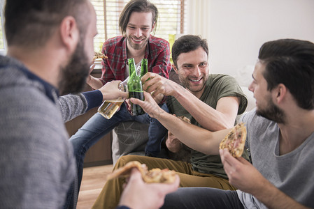 男人吃披萨喝酒啤酒让我们庆祝我们没图片