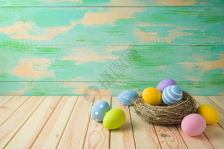 复活节假期背景与复活节彩蛋在木桌上的鸟巢背景图片