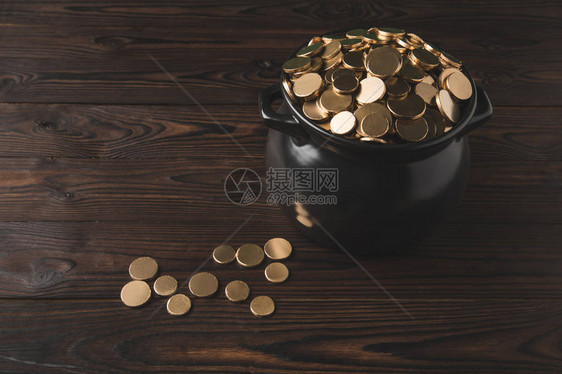 木制桌上金币罐子高角度视图图片