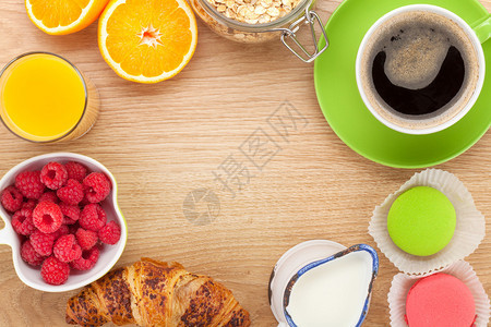 与梅斯利浆果橙子橙汁咖啡和羊角面包的健康的早餐在带复制空间图片