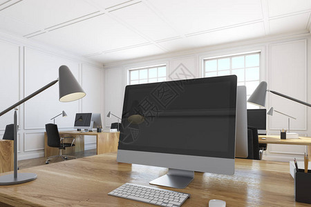 白色办公室的木制桌子上站立着黑电脑屏幕的近闭公司工作的概念图片